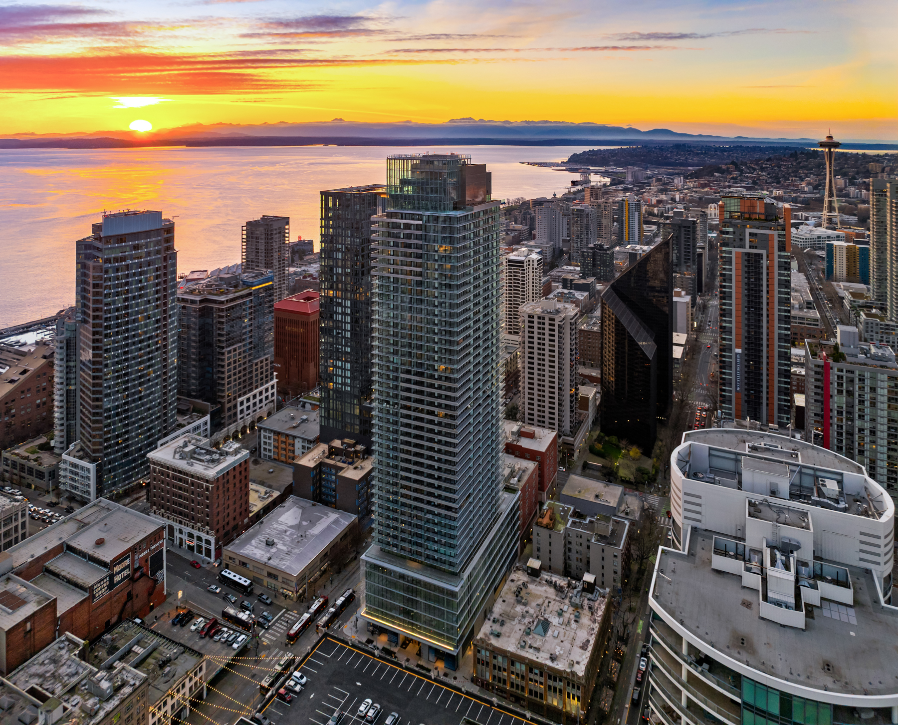 Landmark residential tower against an Elliott Bay sunset